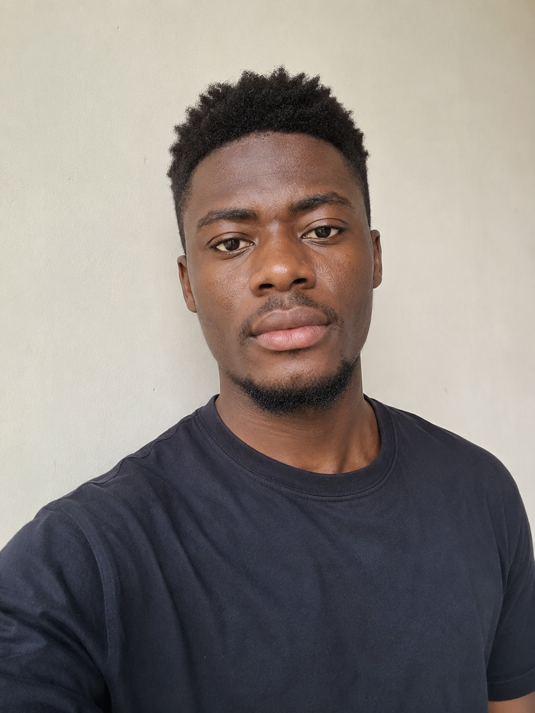 Kwame, a frequent traveller, portrait in a dark t-shirt